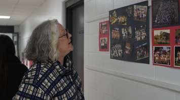 Dawn Ziolkowski looking at photos at Sacred Heart (Photo by: Lindsay Newman/ Blackburn Media)