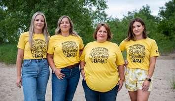 Suicide loss survivors Marnie Vandenbroek-Hookey, Leanne Fera and Chynna DaSilva join Suicide Loss Support Group Co-Facilitator Heather Taylor (third from right) to model t-shirts designed for Suicide Prevention Day on September 10. Submitted photo by Julie MacCrae Photography.