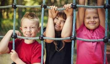 File photo of children at a playground courtesy of © Can Stock Photo / gpointstudio