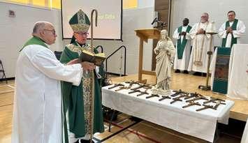 Bishop Ronald Peter Fabbro blessing the crosses at Sacred Heart Catholic School (Photo by: Lindsay Newman/ Blackburn Media)